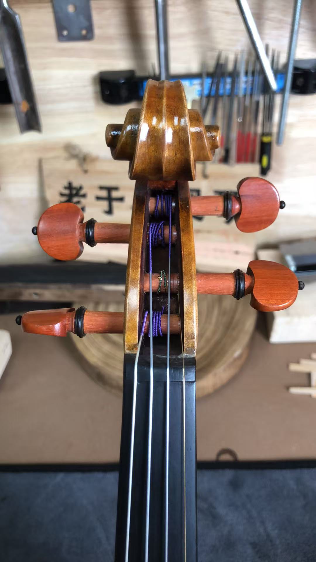 A workshop batch label fixed to the ribs of a violin in production