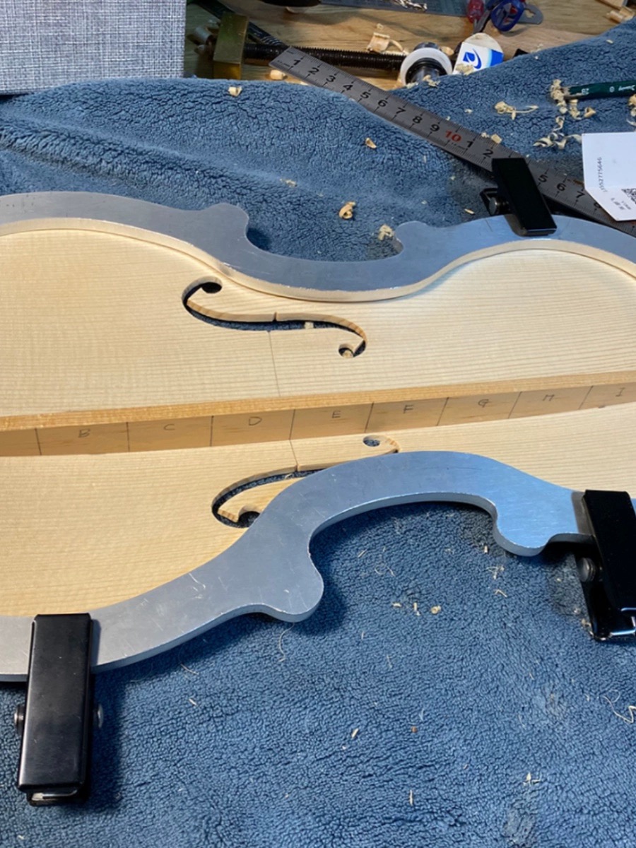 A shaped hard violin case, batch-labelled in our workshop