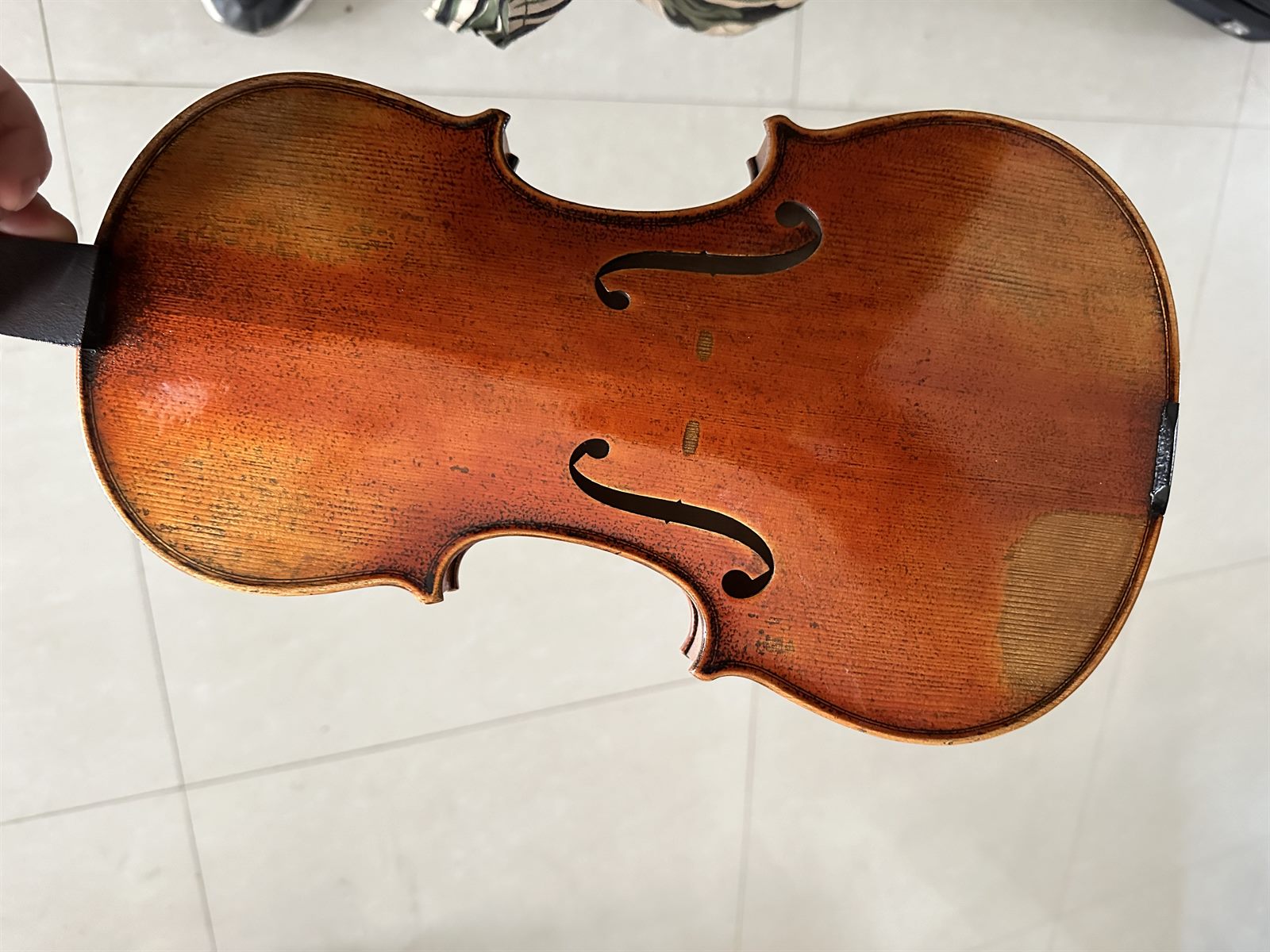 A violin secured inside its case with the bow, ready to ship